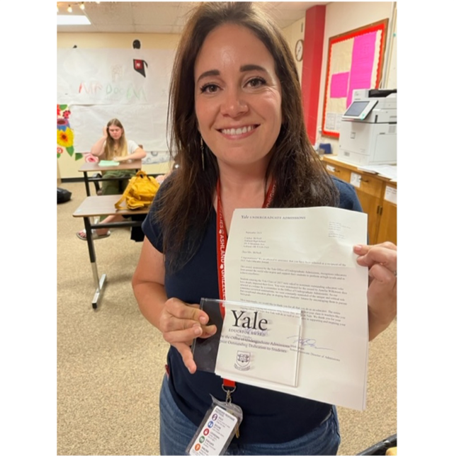 teacher with award