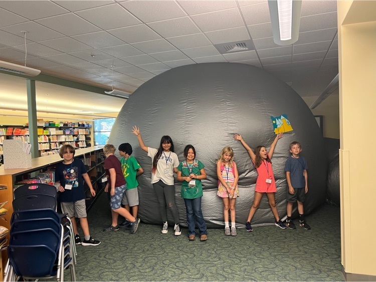 Blow up dome planetarium with students posing in front