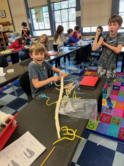 3rd graders and their long necked creations