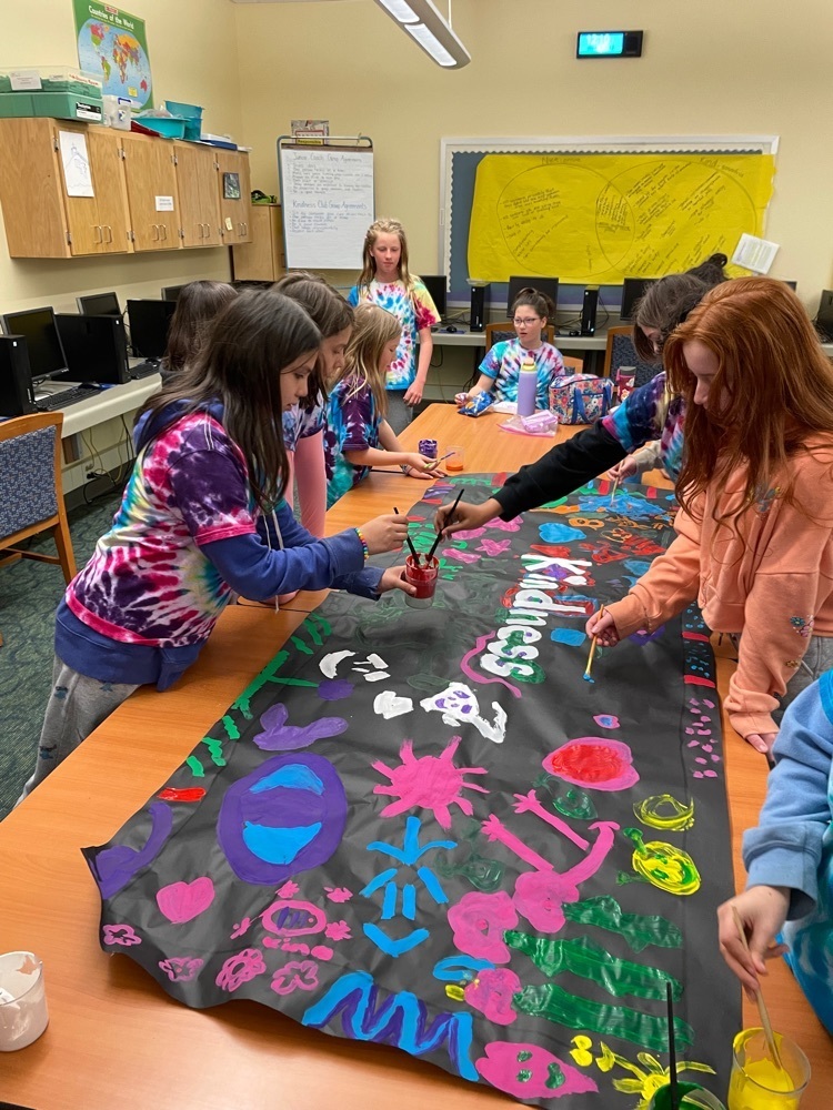 Kindness Club working on a banner 