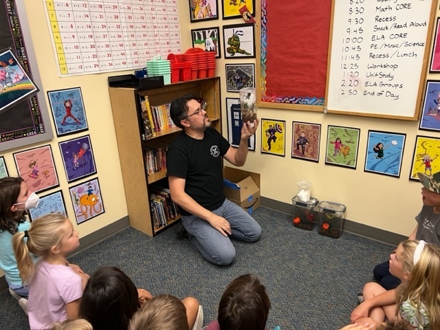 Mr. Carnes shares his pink toed tarantula with Ms. Hanson's second graders